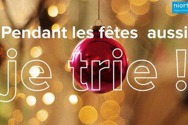 Campagne Niort Agglo : boule de Noël rouge suspendue avec le slogan « Pendant les fêtes aussi, je trie ! »